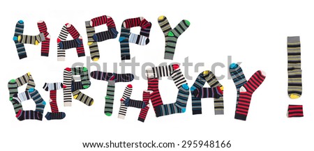 Happy birthday expression made from socks. Multicoloured socks are organized in two lines isolated on white background.
