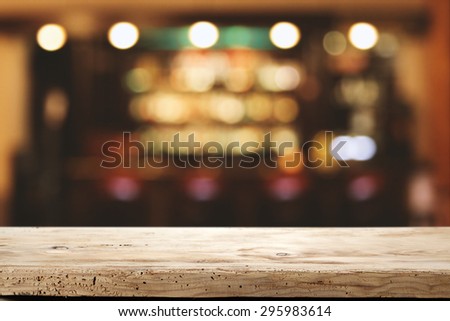blurred background of bar and wooden desk space 