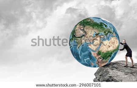 Young businesswoman pushing Earth planet. Elements of this image are furnished by NASA
