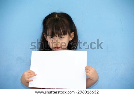Cute Asian girl holding a white paper. For the text or image
