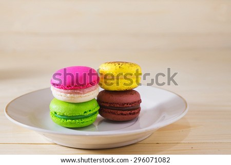 Macarons on wooden table and background