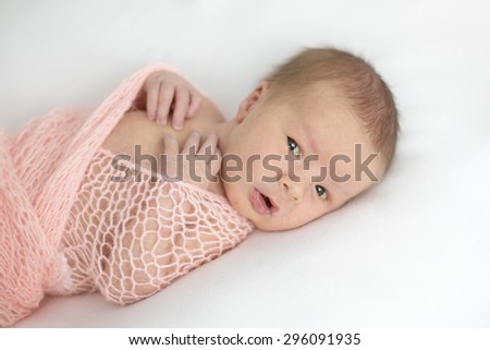a newborn baby looks in the picture