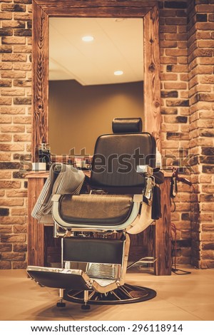 Client's chair in barber shop Royalty-Free Stock Photo #296118914