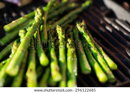 Asparagus on grill at sunset, candid picture