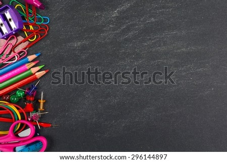 School supplies side border on a chalkboard background Royalty-Free Stock Photo #296144897