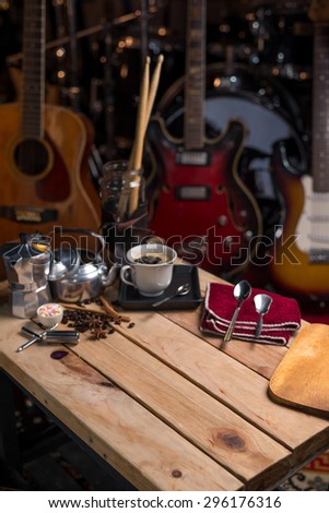 coffee on wood table background with musical instrument