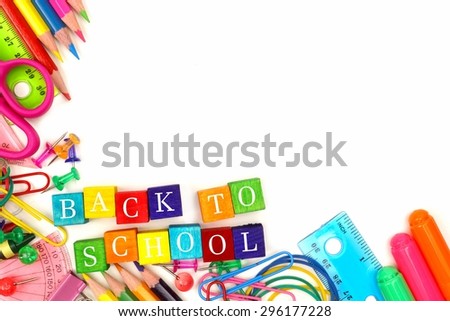 Colorful Back to School wooden blocks with school supplies corner border over white