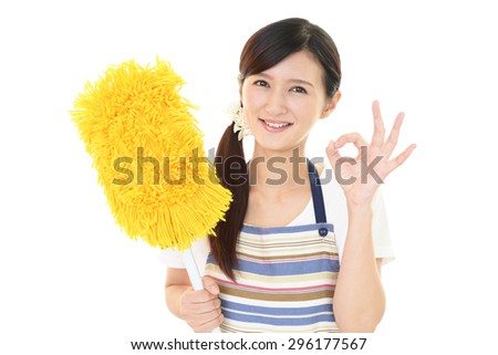 Smiling woman cleaning the house