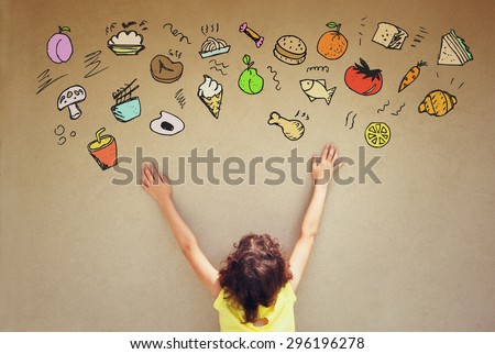 back view of cute kid imagine various foods with set of infographics over textured wall background
