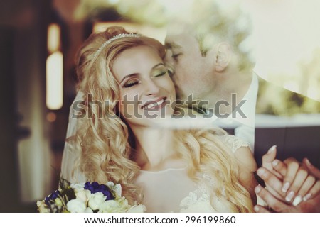 elegant stylish groom with his happy gorgeous blonde bride in the restaurant