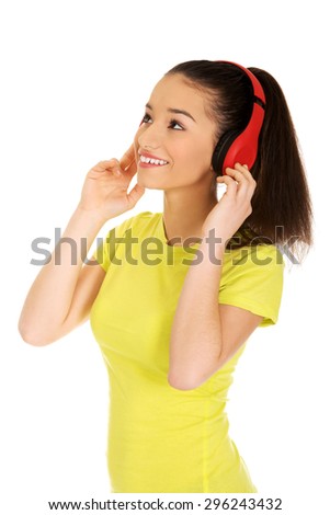 Young teenage woman with headphones listening to music.