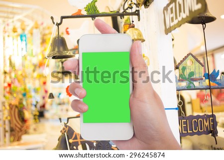 Photo blank. Women hand holding blank mobile smart phone in the shopping mall.