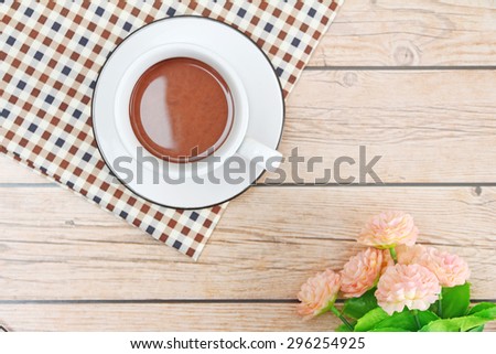 Coffee fresh cup on wooden table background and flower