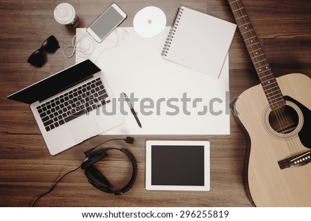 Office desk background, Acoustic guitar and headphones recording scene project ideas concept, With laptop computer, mobile phones, drawing equipment and cup of coffee. View from above with copy space