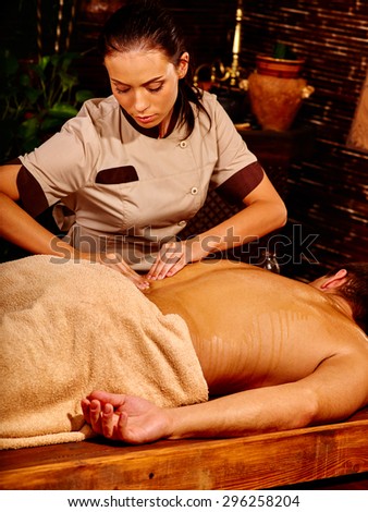 Man  having oil Ayurveda spa treatment. Body part of part.