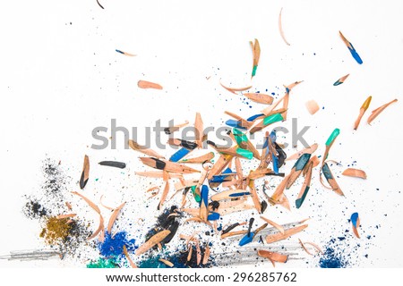 Colorful pencil wood shavings with blue, green, beige  crumbs on a white background 