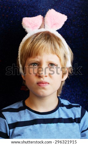 Cute 7 years old boy with bunny ears