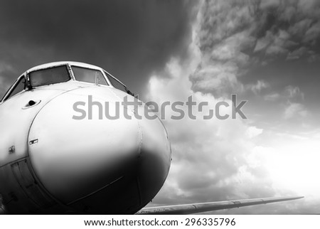 closeup flying airplane on sunset in motion. black and white picture