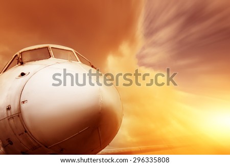 closeup flying airplane on sunset in motion. vintage picture