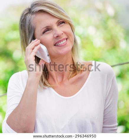 beautiful smiling blond woman talking on the phone