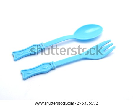 Plastic baby spoon on a white background