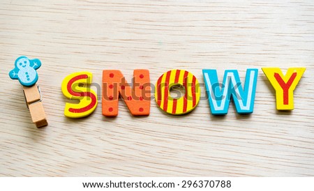 Weather symbol on wooden clothes peg and colourful text. Concept of climate weather. Slightly de-focused and close up shot. Copy space.