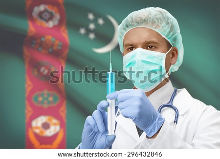 Doctor with syringe in hands and flag on background - Turkmenistan