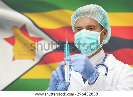 Doctor with syringe in hands and flag on background - Zimbabwe