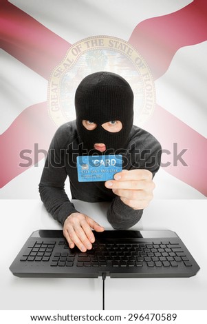 Hacker in black mask with USA state flag on background - Florida