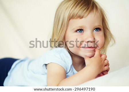 closeup portrait of a funny little girl. child playing at home