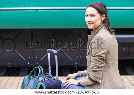 travel portrait of a beautiful adult woman on vintage passenger car background