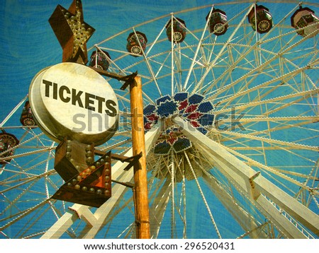 aged and worn vintage photo of  ferris wheel and ticket sign                             