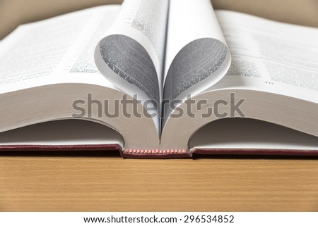 book shape heart on wood background