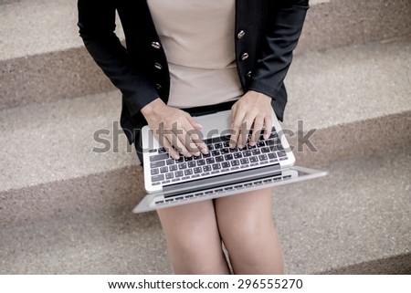 Successful businesswoman working at laptop