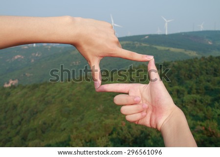 Hands framing the mountains