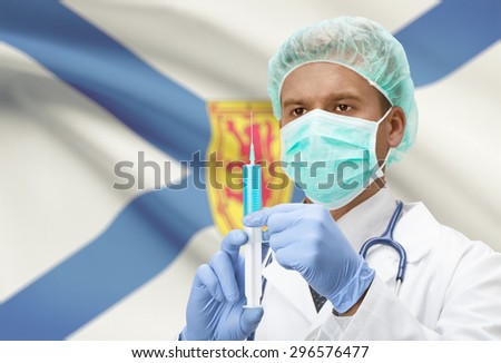 Doctor with syringe in hands and Canadian province flag on background - Nova Scotia