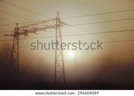 Power lines on a foggy and cold morning. Image has a vintage effect applied.