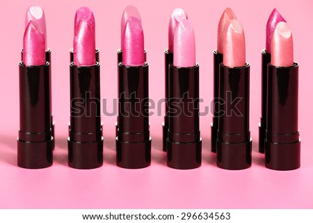 black tubes of lipsticks and pink space 