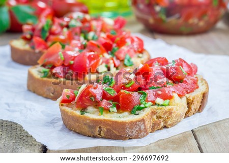 Bruschetta with tomatoes, herbs and oil on toasted garlic cheese bread Royalty-Free Stock Photo #296697692