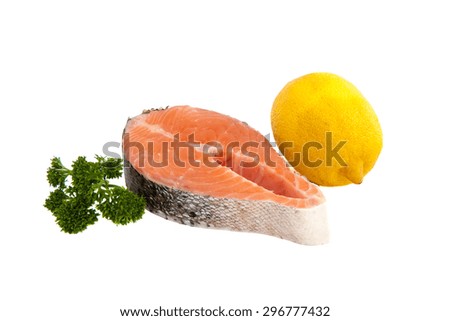 close-up raw salmon steak, lemon and parsley isolated on white background