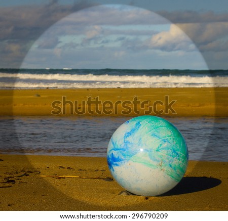 concept image for global environmental issue using inflatable rubber ball with earth like markings and rippled water surface 