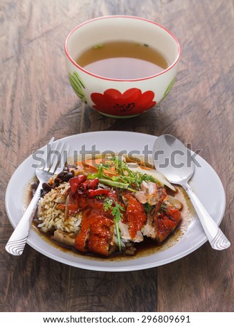 Red roasted duck with sauce and soup chinese food and soup on wood table background
