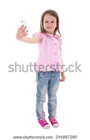 funny cute little girl taking selfie photo with smart phone isolated on white background