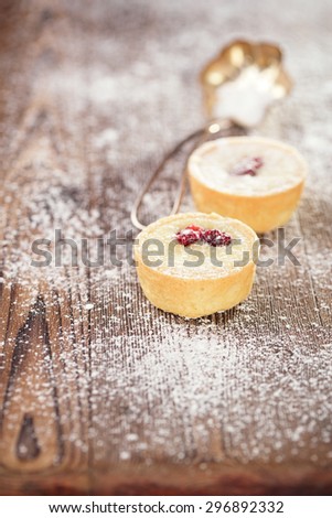 white Chocolate  Mini Tartlets on vintage wooden table  with dusting sugar