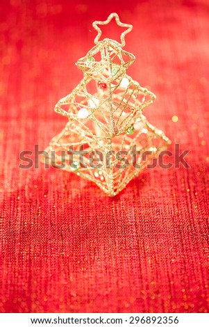glitter christmas tree decoration on golden red background