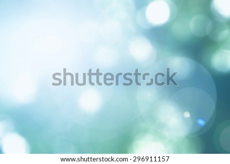 Vintage cool cyan blue green color blurred sky background with nature glowing sun light flare and bokeh