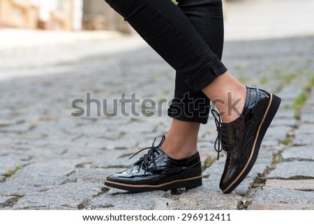 Close up of stylish female shoes.  Outdoor fashion shoes footwear concept. Royalty-Free Stock Photo #296912411