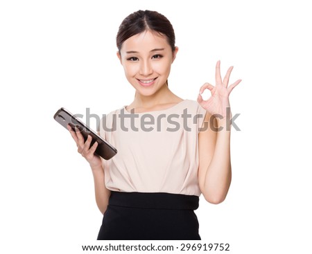Asian woman hold with tablet and ok sign gesture