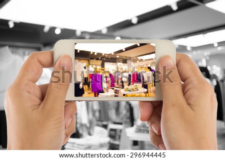 Taking a picture with a smart phone in shopping mall.