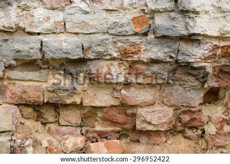 Brick wall made of red stone with a pronounced texture